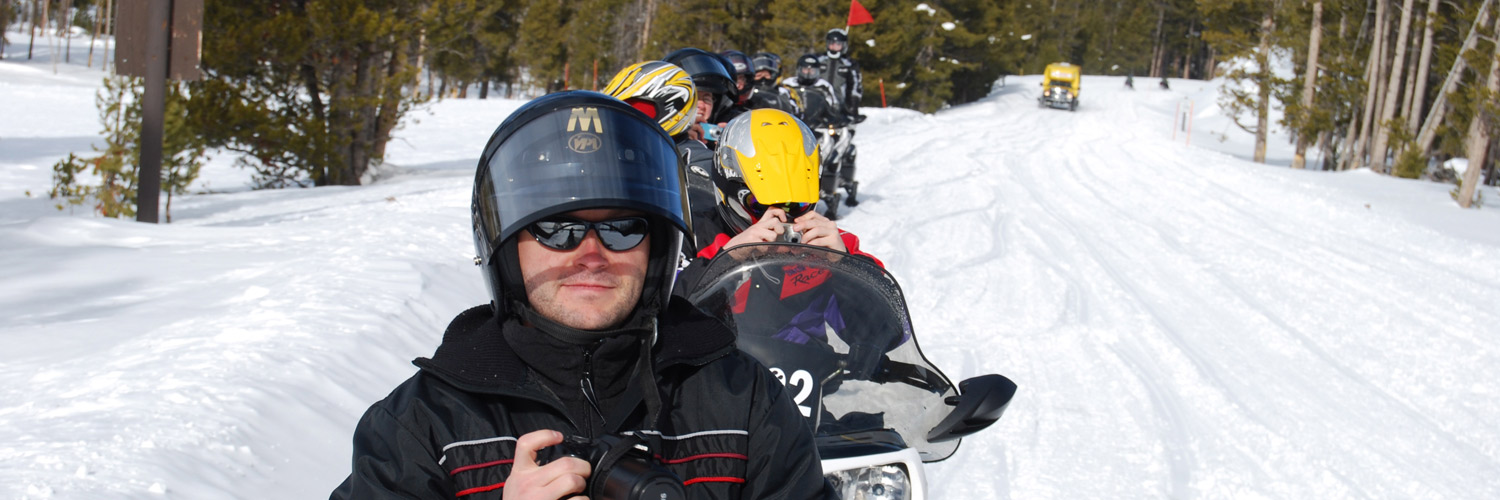 Snowmobile group and snowcoach in Yellowstone National Park