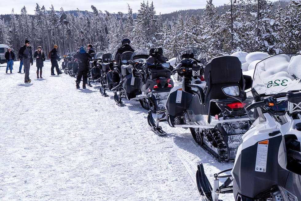 A line of snowmobiles during a tour of Yellowstone National Park