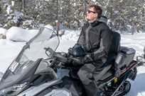 A snowmobile rider takes a break during their tour of Yellowstone